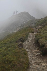 Walkers vanishing into low cloud near Hopegill Head, Lake District, Cumbria